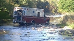 Almond Ambulance Hits House, Plunges Into Creek