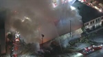Fire tears through roof of Los Angeles commercial building, sends plume of smoke into air